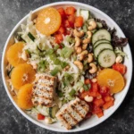 High-volume chicken salad bowl with cabbage, mandarin oranges, cucumbers, peppers, and cashews – ideal for volume eating recipes
